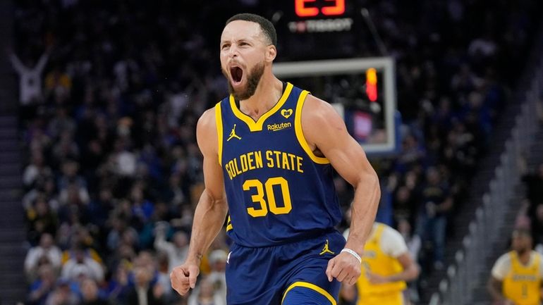 Golden State Warriors guard Stephen Curry (30) reacts after making...