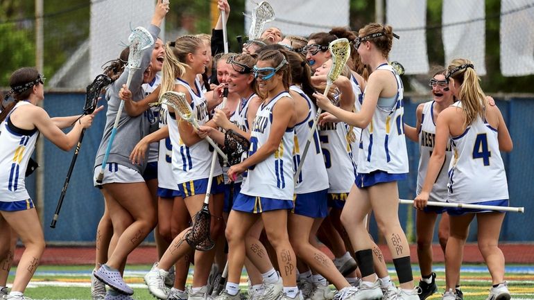 The West Islip girls celebrate their win over Eastport-South Manor,...