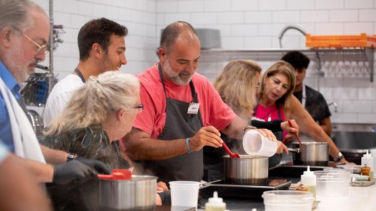 Making arancini (Sicilian rice balls) at The Babylon Mercantile in...