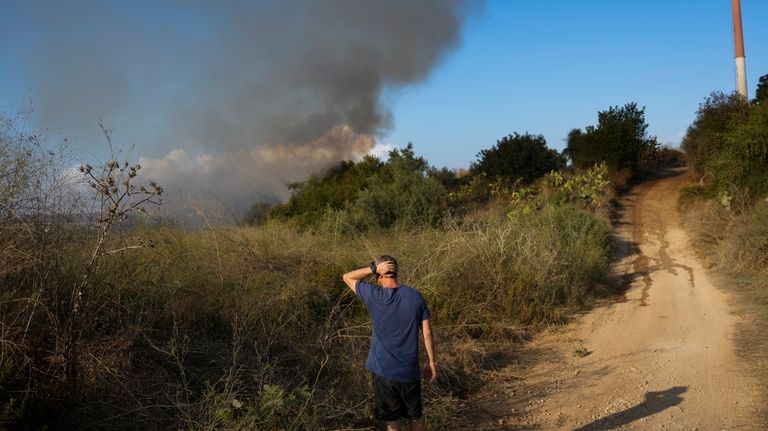 Smoke rises from a fire in central Israel after the...