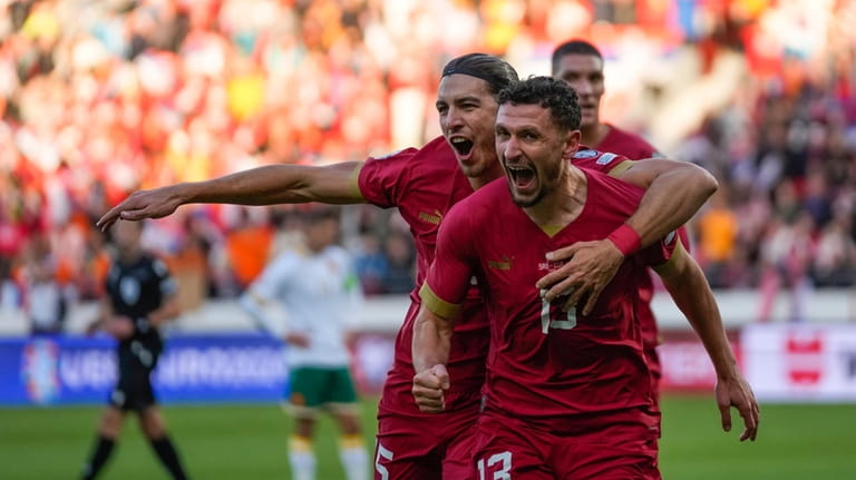 Serbia's Milos Veljkovic, centre, celebrates after scoring his side's opening...