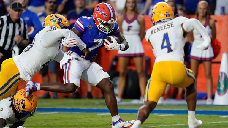 Florida running back Trevor Etienne (7) is stopped by McNeese...