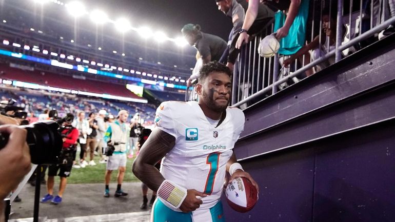 Miami Dolphins quarterback Tua Tagovailoa jogs off the field after...