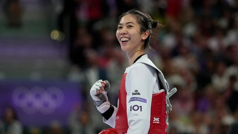 Thailand's Panipak Wongpattankit celebrates after winning the women's 49kg Taekwondo...