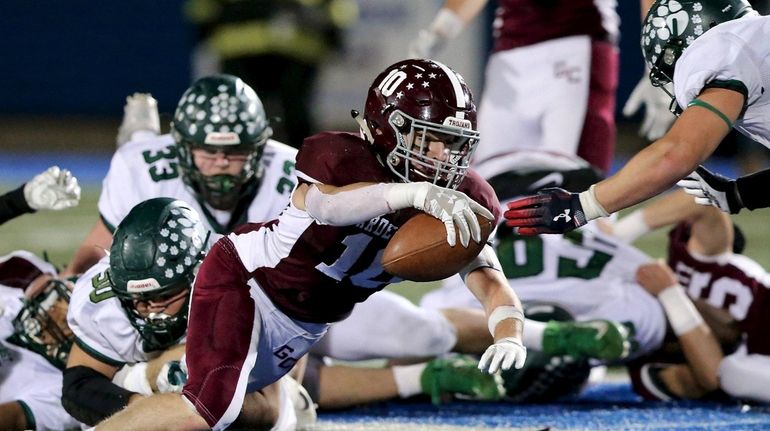 Garden City RB Pierce Archer dives for extra yardage against...