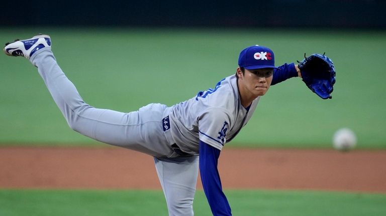 Los Angeles Dodgers pitcher Yoshinobu Yamamoto throws against the Texas...