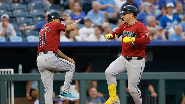 Arizona Diamondbacks' Joc Pederson (3) celebrates with third base coach...