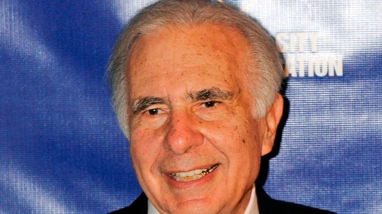 Financier Carl Icahn poses for photos upon arriving for the...