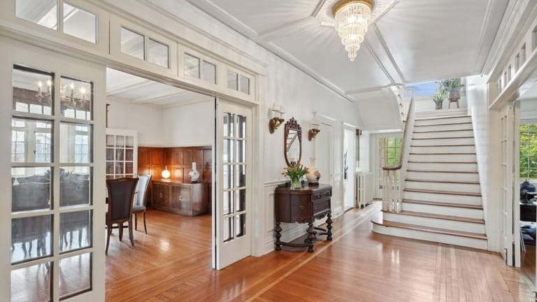 Original paneling, molding, hardwood floors and curved handrails remain intact...