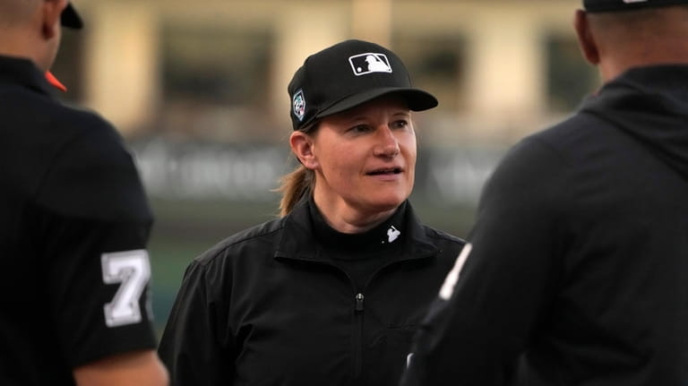 Umpire Jen Pawol participates in the lineup card exchange before...