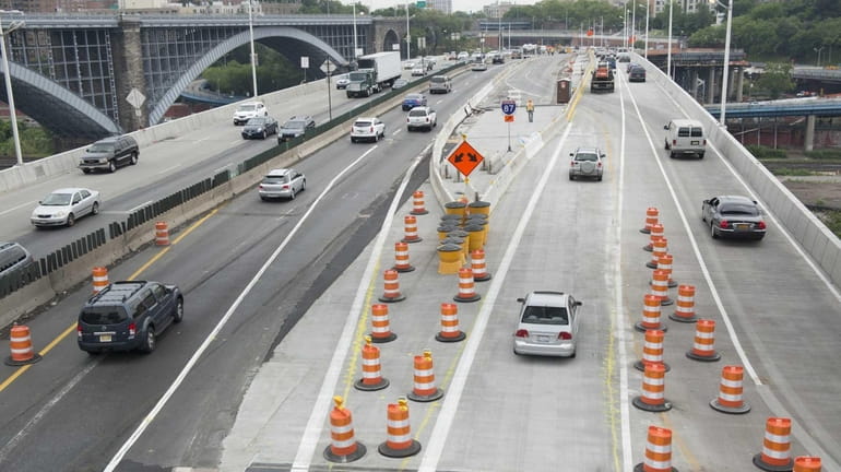 Orange barrels separate driving lanes as traffic will be rerouted...