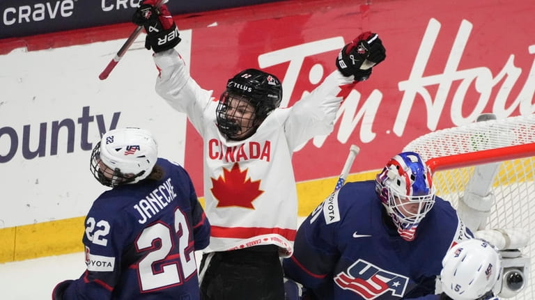 FILE -Canada's Danielle Serdachny (92) celebrates the goal by teammate...