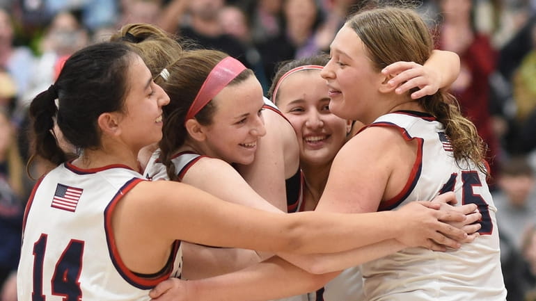 Sara Kealey of MacArthur, second from left, celebrates with teammates after...