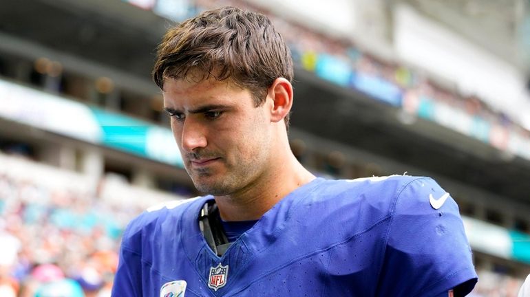 Daniel Jones of the Giants leaves the field after an injury against...