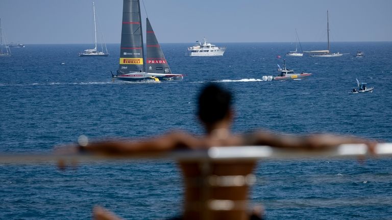 A spectator watches the race as Luna Rossa Prada Pirelli...