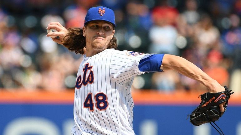 New York Mets starting pitcher Jacob deGrom delivers a pitch...