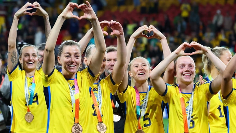 Sweden gesture to supporters as they celebrate with their bronze...