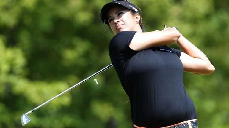 Gerina Piller watches her tee shot on the first hole...