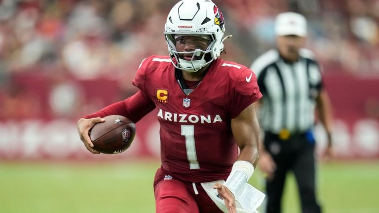 Arizona Cardinals quarterback Kyler Murray (1) runs out of the...