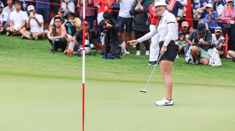 Hannah Green of Australia reacts after scoring a putt on...