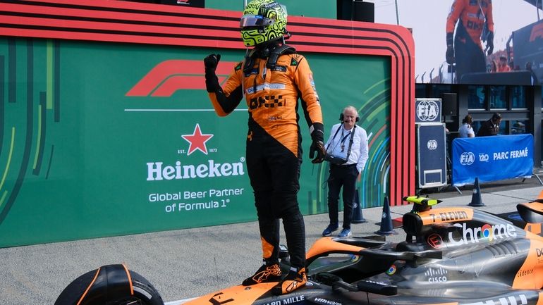 McLaren driver Lando Norris of Britain celebrates after winning the...