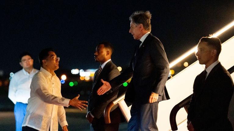 U.S. Secretary of State Antony Blinken is greeted by Philippine...