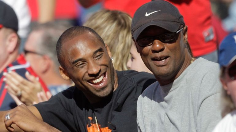 Los Angeles Lakers' Kobe Bryant, left, talks to his father,...