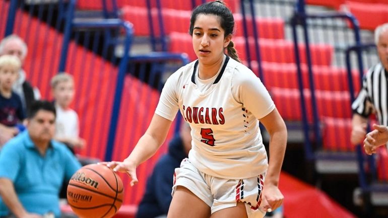 Jayla Fowler of St. John the Baptist dribbles down court...