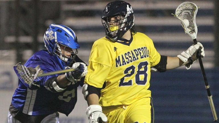 Paul Dilena of Massapequa gets by Jesse Kaplan of Port...