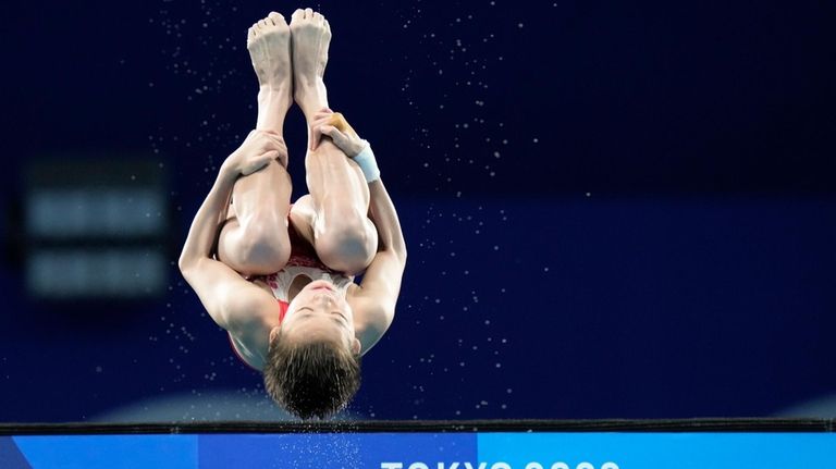 Quan Hongchan of China competes in women's diving 10-meter platform...