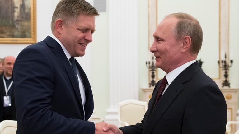 Russian President Vladimir Putin, right, shakes hands with Slovak Prime...