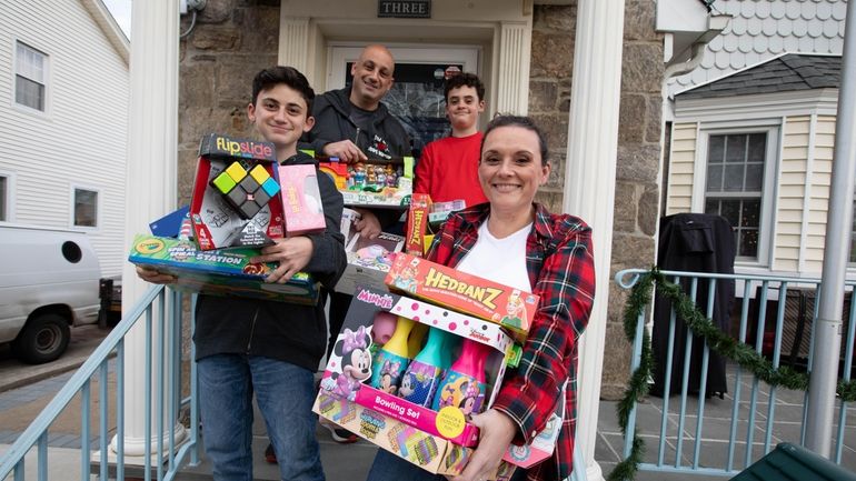 Shannan Pearsall and husband Nick with sons, Aidan, 14, in front,...