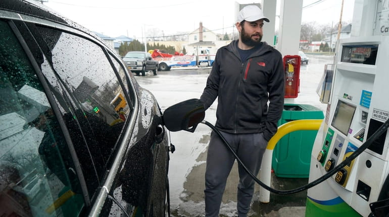 Max Weiss pumps gas in Port Washington in March. Gas prices have...