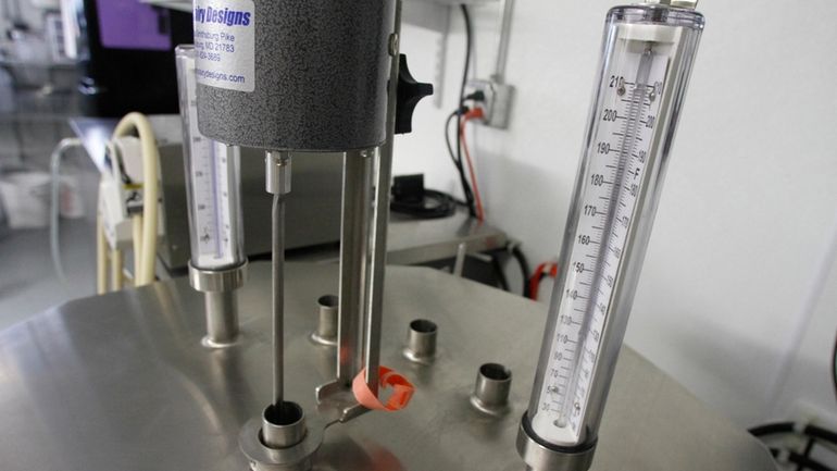 Thermometers are seen atop a small-scale pasteurizer in Plainfield, Vt.,...