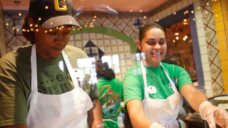 Latrice Walker and Christina Rivera make fresh tortillas on opening...