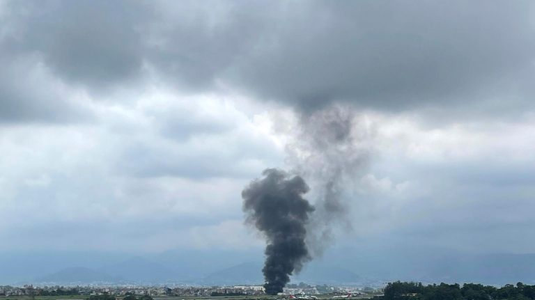 Smoke rises from the Tribhuvan International Airport in Kathmandu, Nepal,...