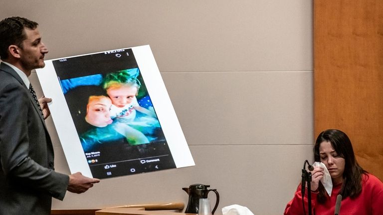 Prosecutor Christopher Knowles shows an enlarged photo of Kayla Montgomery...