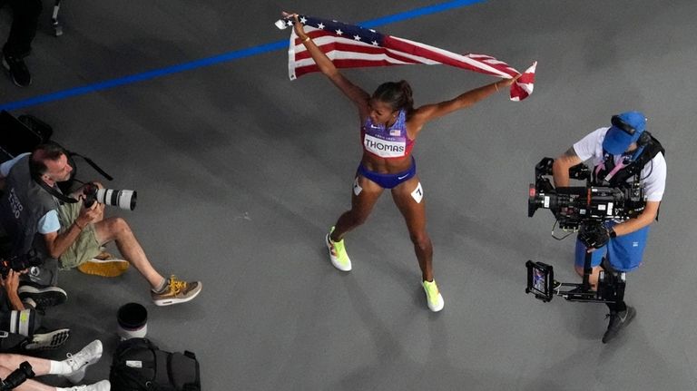 Gabrielle Thomas, of the United States, celebrates after winning the...