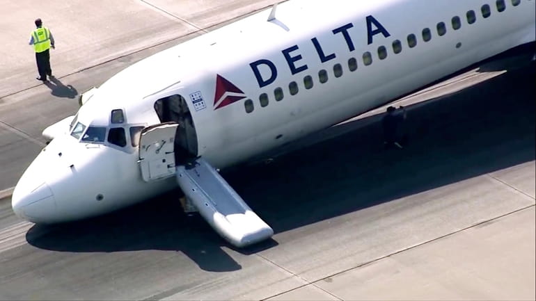 A Delta plane lands without its landing gear at the...