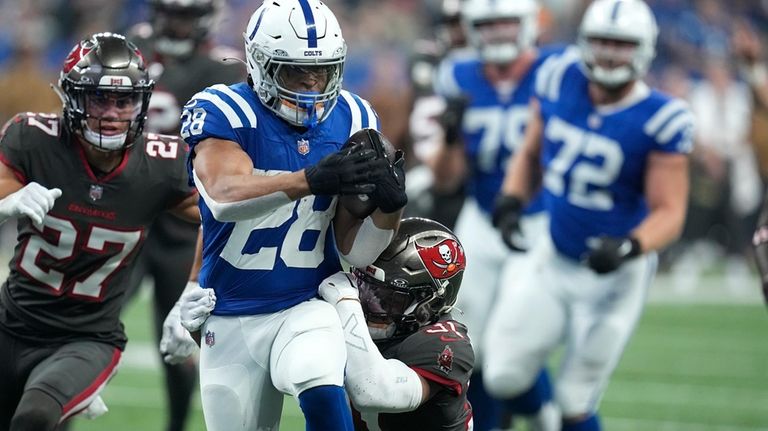 Indianapolis Colts running back Jonathan Taylor (28) runs the ball...