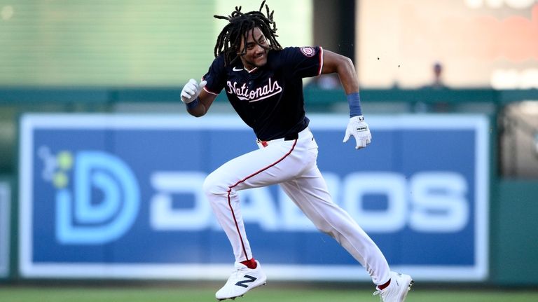 Washington Nationals' James Wood runs on his single and advances...