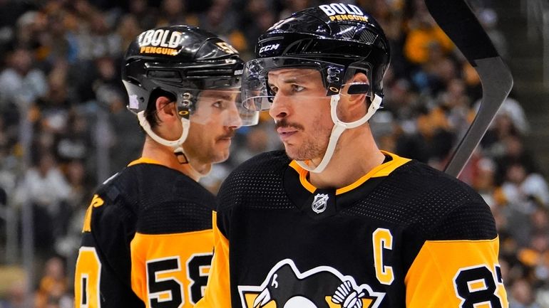 Pittsburgh Penguins' Sidney Crosby (87) and Kris Letang (58) play...