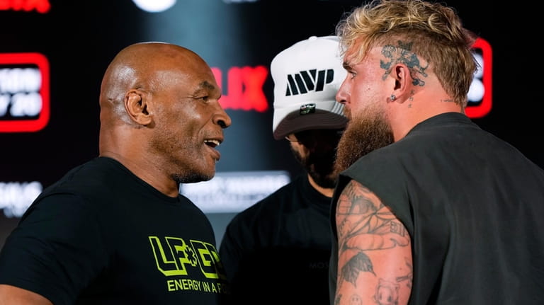 Mike Tyson, left, and Jake Paul, right, face off during...