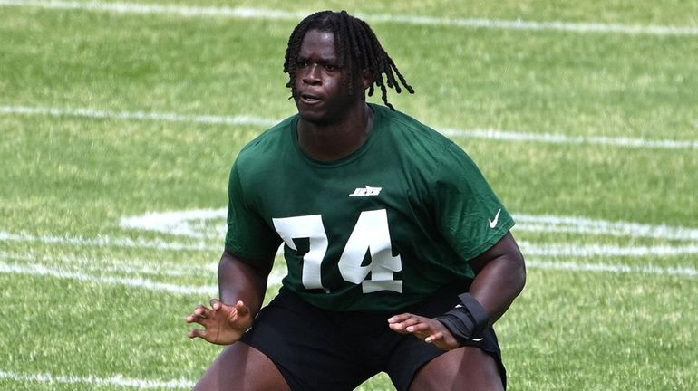 Jets offensive lineman Olu Fashanu  performs non-contact agility drills during...