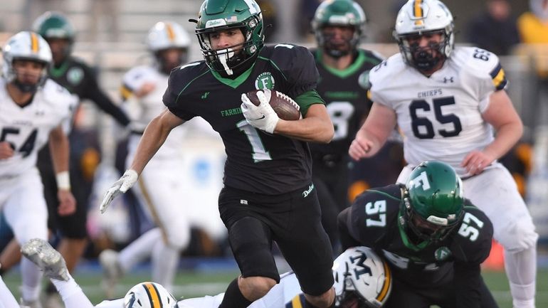 Tomaso Ramos #1 of Farmingdale evades a tackle during the...