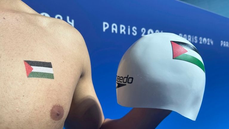 Palestinian swimmer Yazan Al Bawwab poses with his swim cap...