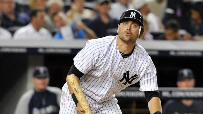 Francisco Cervelli watches the flight of the ball on a...