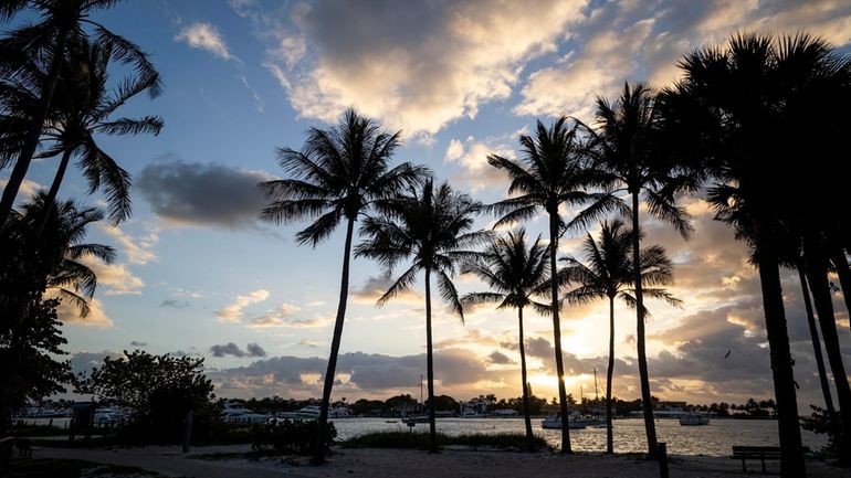 The sun rises over Peanut Island, an 80-acre piece of...