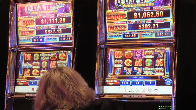 A gambler plays a slot machine at the Tropicana casino...