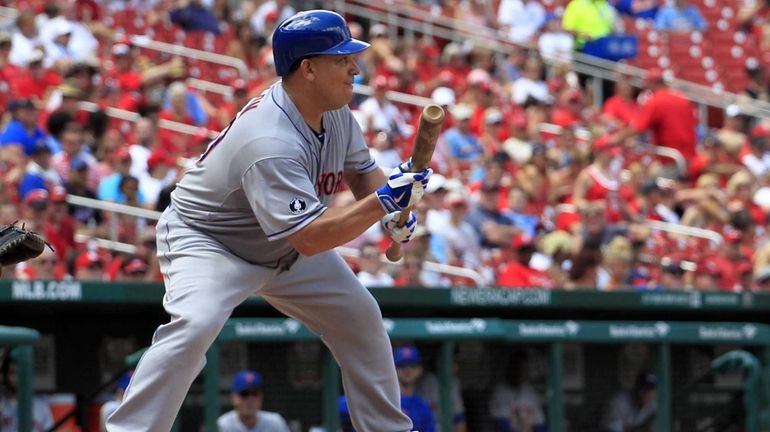 Mets' Bartolo Colon shows a bunt as he bats during...